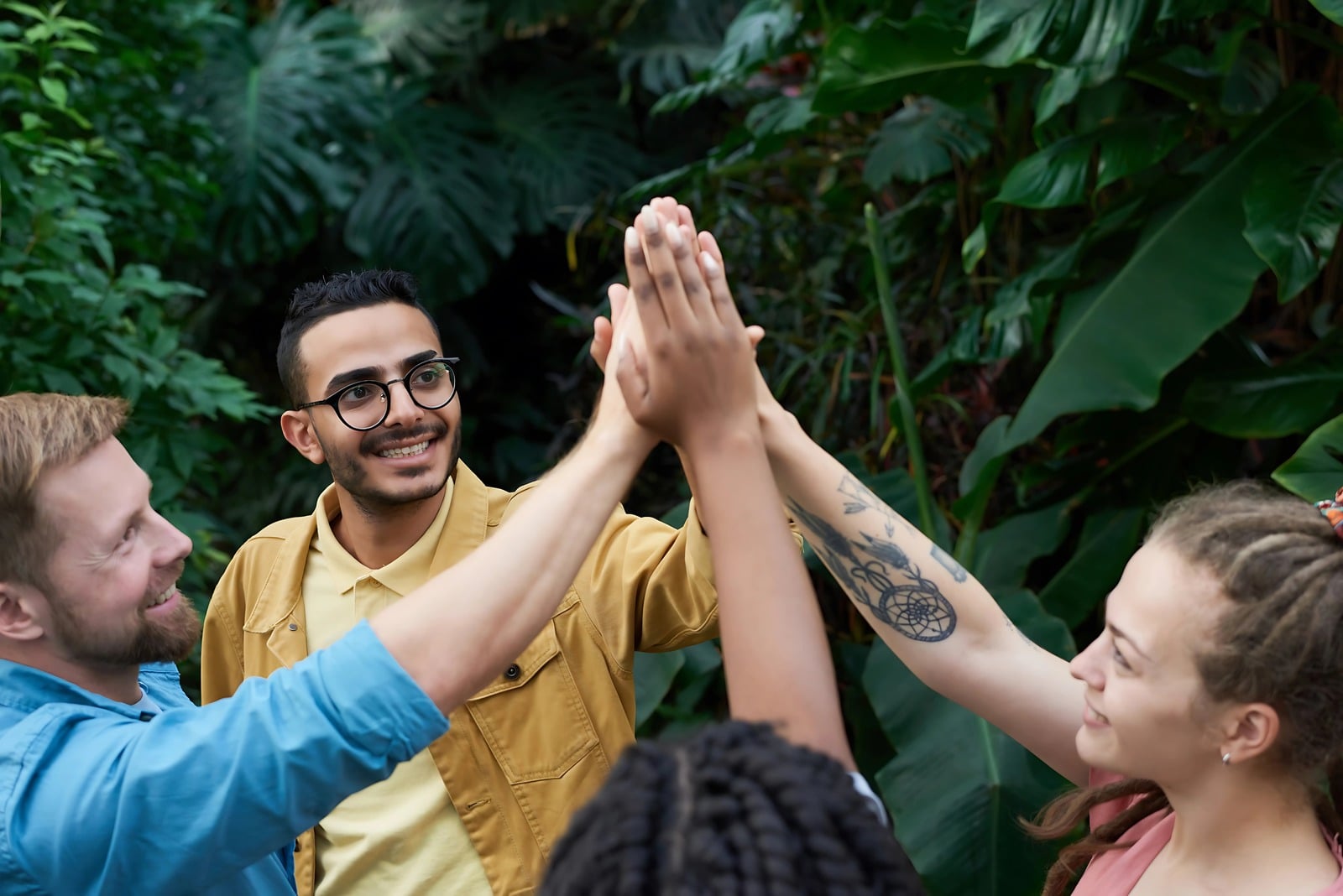Friends celebrating together surrounded by greenery